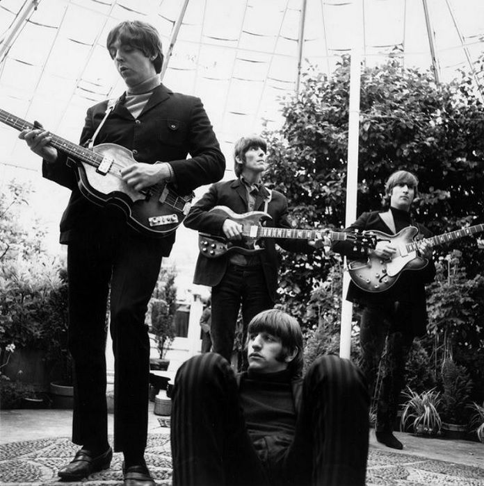 The beatles in a conservatory with Ringo sitting on the floor