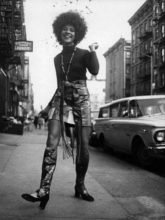 Woman with afro strutting down street