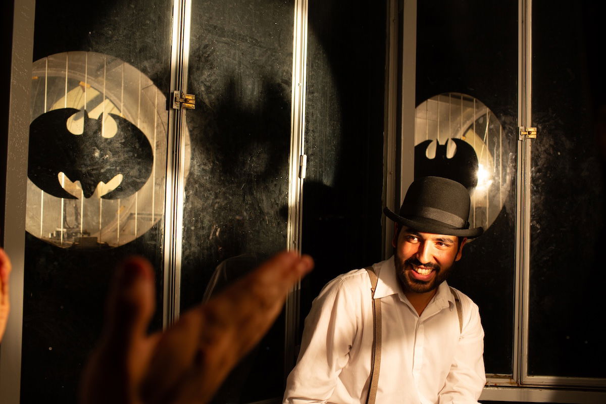 image of man on stage with bowler hat