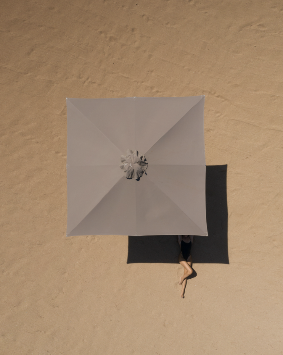 photo of a parasol on a beach from above