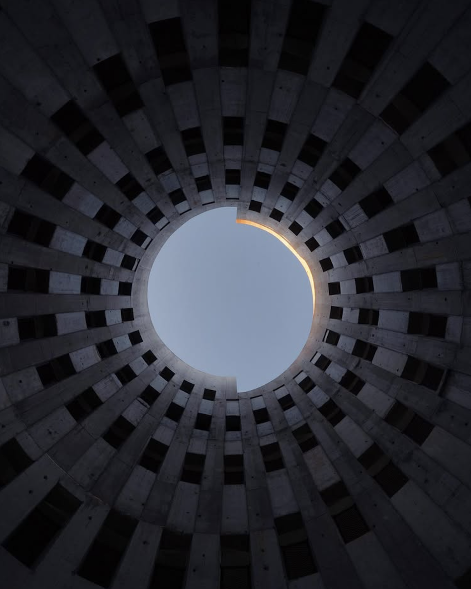 photo taken in the middle of building looking up at the sky