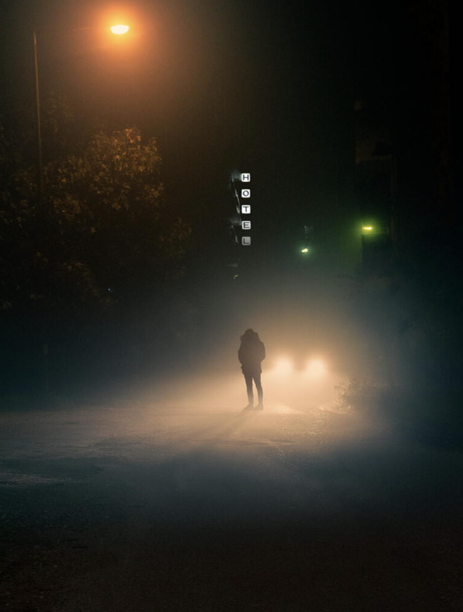 photo of person in headlights on a misty night 