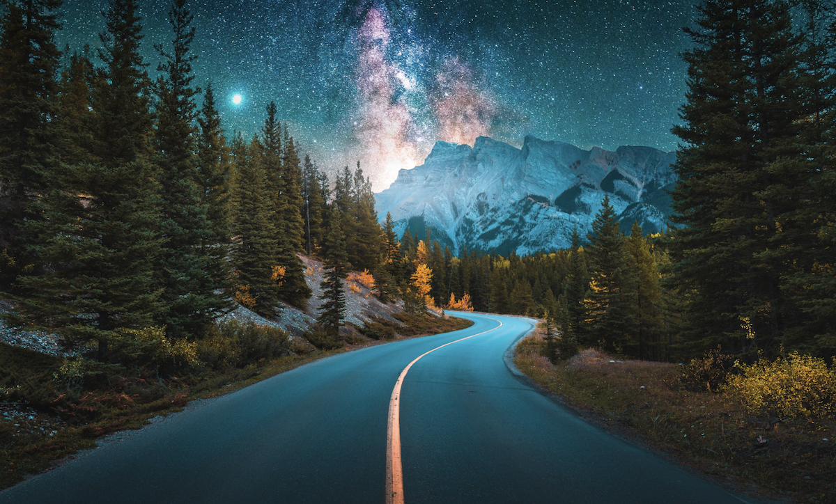 photograph of mountain road at night heavily edited